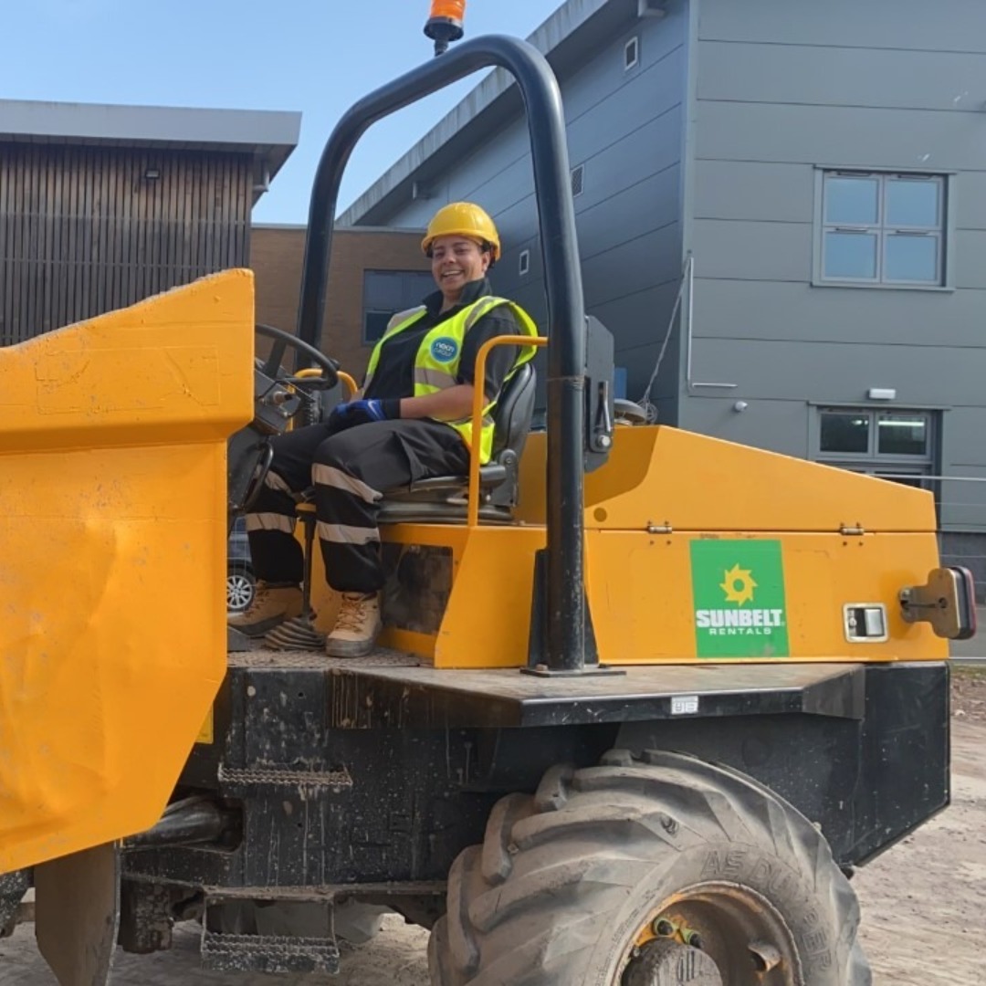 Groundworks and Plant student Amy Johnson sitting on a dumper truck onsite at the Wellington Road campus