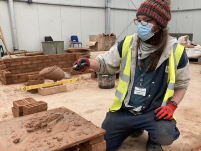 Luke Risbey - construction and plant operations student laying bricks