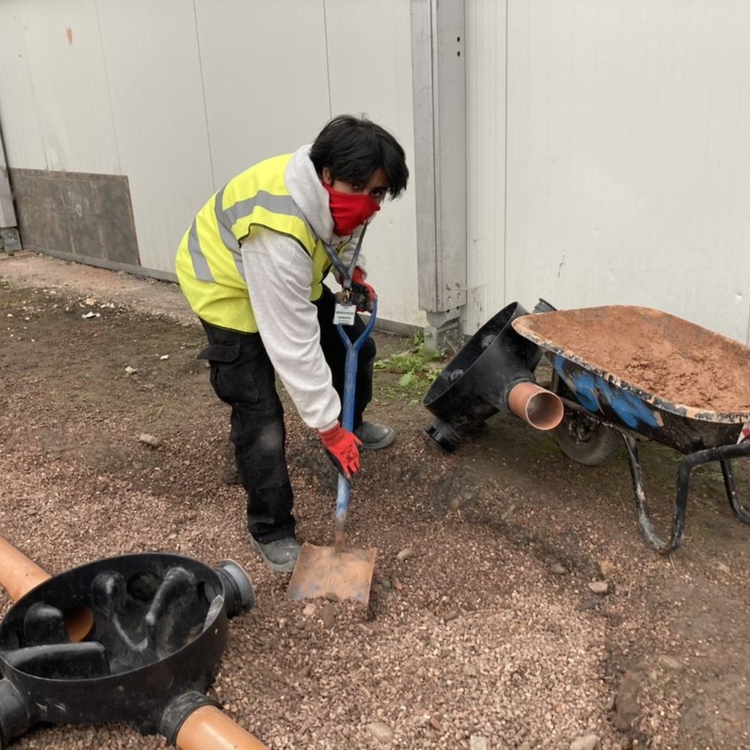 Rohan Amir - groundworks and plant operative student digging a trench