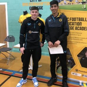 Wolves player Luke Cundy, left and student Mustafa Hussain wearing black Wolverhampton Wanderers-branded tracksuits