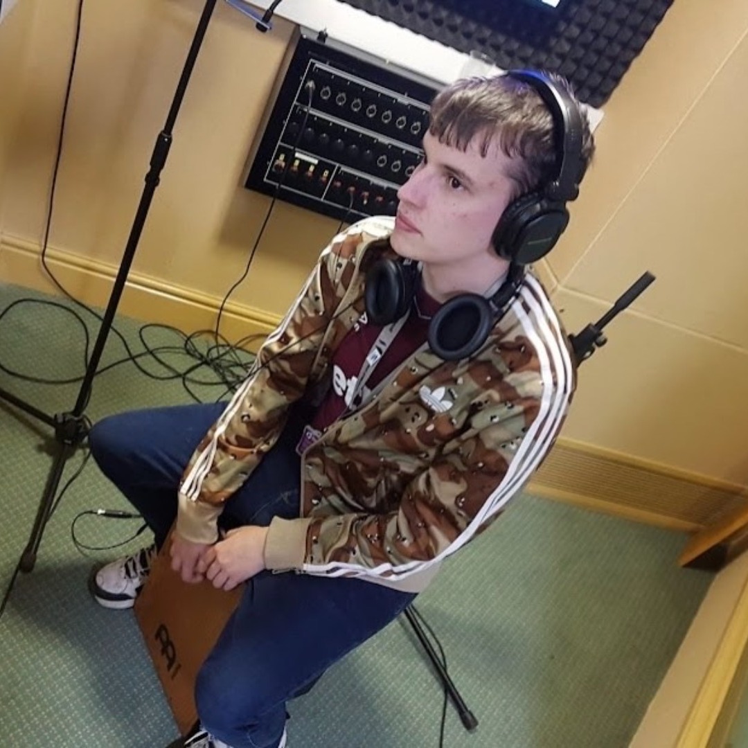 Music technology student Alex Pavey, wearing headphones in the music studio