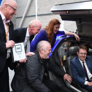 Andy Street, Mayor of the West Midlands sitting in a classic Delorean vehicle, watched by Malcolm Cowgill, principal of the college, MPs Pat McFadden and Jane Stevenson and Cllr Ian Brookfield