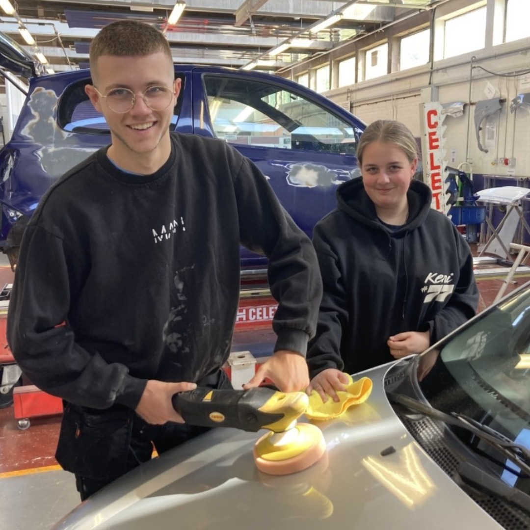 Two automotive students pictured in the workshop