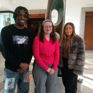 Anastacia Smounam, in a red top, is pictured centre with fellow students Benjamin Henry (left), wearing an black sweatshirt and Grace Fletcher (right), wearing a furry jacket