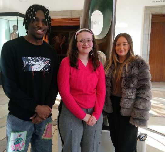 Anastacia Smounam, in a red top, is pictured centre with fellow students Benjamin Henry (left), wearing an black sweatshirt and Grace Fletcher (right), wearing a furry jacket