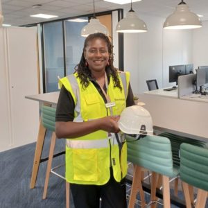 Alsion Lawson wearing a black top, high vis jacket and holding a hard hat