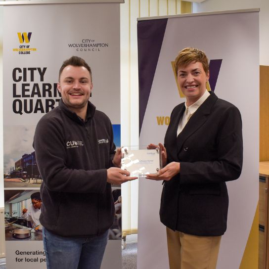 Danny North from Coventry University, left, with Louise Fall, deputy principal, right with a plaque marking the partnership