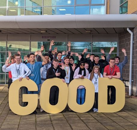 A picture of students in front of letters spelling good